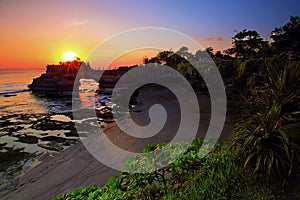 Batu bolong temple in tanah lot bali with beautiful sunset