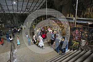 Tourists seen exploring and praying in the Hindu Temple, Batu Caves, Malaysia.