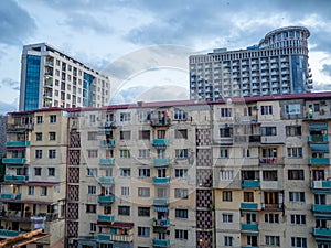 Batumi architecture concept. old house against the backdrop of a new high-rise building. Contrast in architecture. Housing for