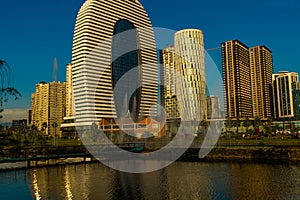 BATUMI, GEORGIA: Department of Justice, Courtyard Marriott Batumi Hotel and skyscrapers are reflected in Lake Ardagani.