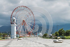 Batumi seafront with ferris wheel lighthouse mountains