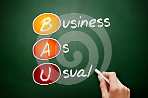 BAU - Business as Usual acronym, business concept on blackboard