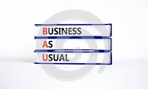 BAU business as usual symbol. Concept words BAU business as usual on books on a beautiful white table white background. Business