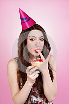 Bautiful caucasian girl blowing candles on her cake