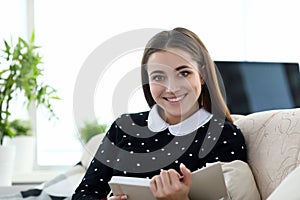 Bautiful woman sit on sofa and read book.