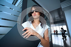 Bautiful young businesswoman in futuristic interio