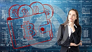 Bauty business woman standing in suit with Bitcoin Logo to illustrate the use of bitcoin for trading or money transfer.