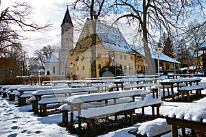 Bavarian beer garden in winter covered in snow