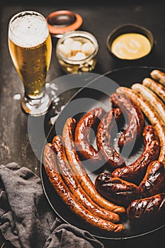 Bavarian dinner with lager beer, sausages, sauce in jars