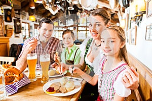 Bavarian family in German restaurant eating