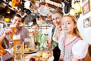 Bavarian family in German restaurant eating