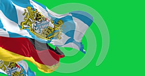 Bavarian flags waving with national german flag isolated on green background
