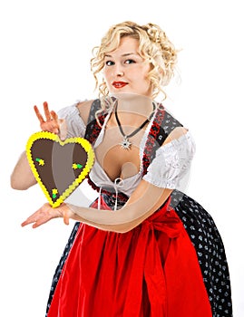 Bavarian girl in dirndl with octoberfest cookie