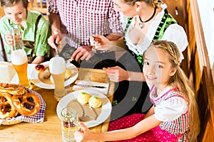 Bavarian girl with family in restaurant