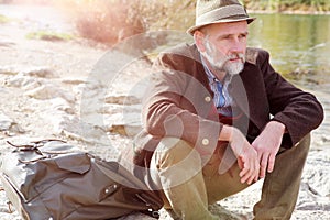 Bavarian man in his 50s sitting by the river