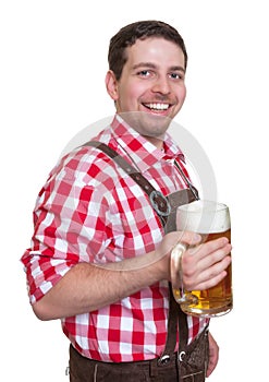 Bavarian man with leather pants drinking beer from a mug