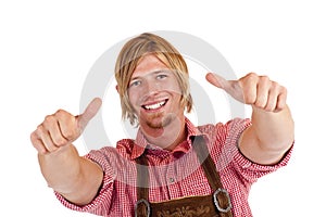 Bavarian man with Lederhose shows both thumbs up