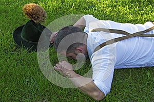 Bavarian man lying on the grass