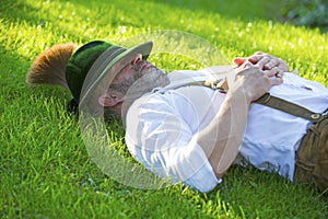 Bavarian man sleeping on the grass