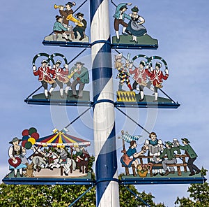 Bavarian Maypole on Viktualienmarkt, Munich, Germany. Symbols of photo