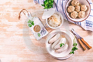 Bavarian white sausages with sauerkraut and bread dumplings, with mustard