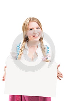 Bavarian woman in dirndl, holding blank signboard.