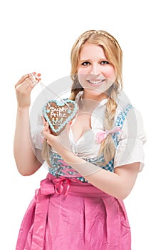 Bavarian woman in dirndl, holding lebkuchen.