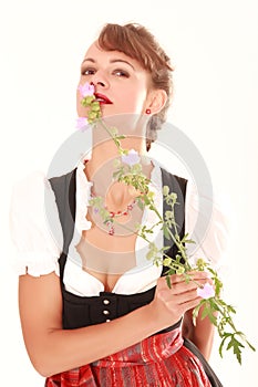 Bavarian woman smelling flower