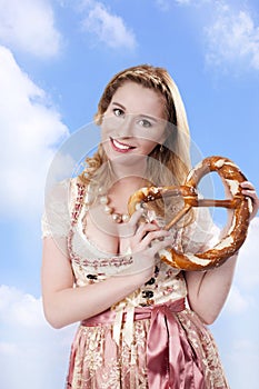 Bavarian woman in traditional costume with bretzel