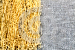 Bavette pasta spaghetti on a burlap cloth with a dark background