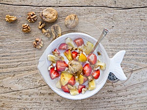 A bawl of fruit, walnuts and yogurt