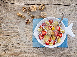 A bawl of fruit, walnuts and yogurt