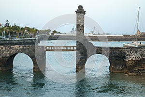 Stone bridge over the port and the sea photo