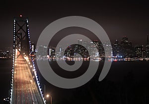 Bay Bridge Illuminated in the Night and San Francisco Blanketed by the Clouds