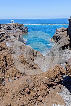 Bay formed by volcanic rocks and the Atlantic Viewpoint in the background in hell in Garachico. April 14, 2019. Garachico, Santa