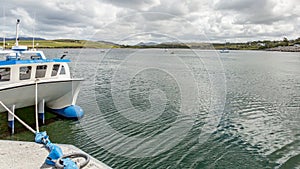 Bay on Inishbofin Island with boats and a ship docked in the harbor photo