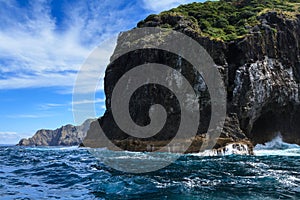 Bay of Islands, New Zealand. The steep cliffs of Motukokako Island