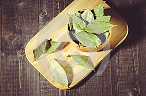 Bay leaf on a tray in a wooden bowl/bay leaf in rural style on a