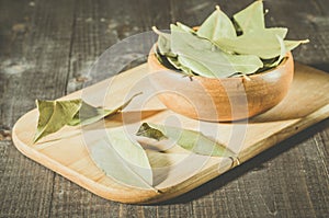 Bay leaf on a tray in a wooden bowl/bay leaf in a wooden plate o