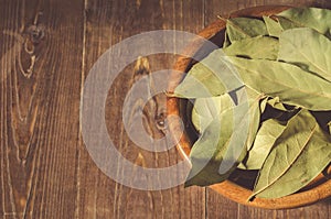 Bay leaf in a wooden bowl/bay leaf in a wooden bowl on a wooden