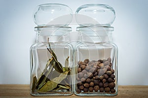 Bay leaves and allspice in a glass jar