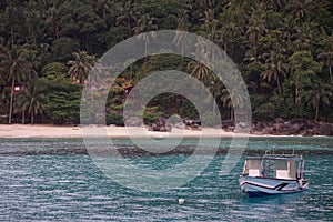 Bay in Malaysian island with blue water and boat