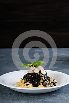 Bay scallop and squid in black ink pasta sauce