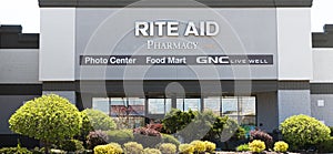 Rite Aid Pharmacy stores exterior with trees and bushes in front