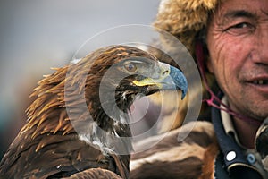 BAYAN-OLGII PROVINCE, MONGOLIA - OCT. 01, 2017: Traditional Golden Eagle Festival. Unknown Mongolians Hunter Berkutchi With G