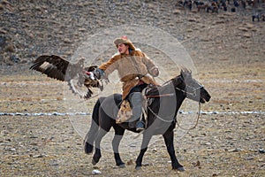 Bayan-Ulgii, Mongolia - October 01, 2017: Golden Eagle Festival.Unknown Mongolian Hunter So Called Berkutchi Astride On Brown