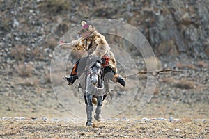 Bayan-Ulgii, Western Mongolia,Golden Eagle Festival, October 01, 2017: Mongolian Rider-Hunter In Traditional Clothes Of Wolf Fur