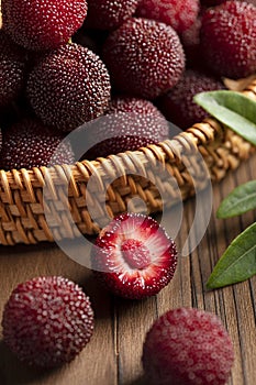 Bayberry on a wooden tabletop indoors, close-up, textured toned(Morella rubra Lour