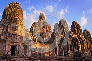 Bayon temple, located in Angkor, Cambodia, the ancient capital city of the Khmer empire. View of the massive stone face towers fro