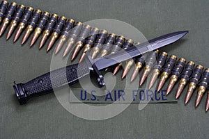 bayonet and ammunition belt on US AIR FORCE uniform background